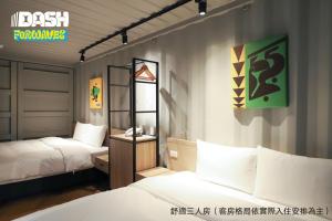 a room with two beds and a sign on the wall at Dash Forwaves Hotel in Toucheng