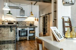 a kitchen with a table and a stove top oven at Citystyle Apartment In Medieval Monflanquin in Monflanquin