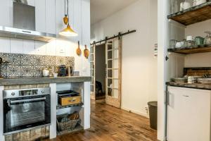 a kitchen with a stove and a counter top at Citystyle Apartment In Medieval Monflanquin in Monflanquin