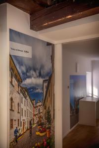 a painting of a city street on a wall at B&B Gli Scorci di Trento in Trento