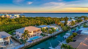 an aerial view of a resort with a marina at Paradise PalmsDockPoolKayaks GrillView! in Marathon