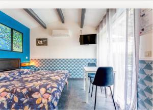 a bedroom with a bed and a table and chairs at Chez Frédérique et Jean-Claude in Les Taillades +42 photos