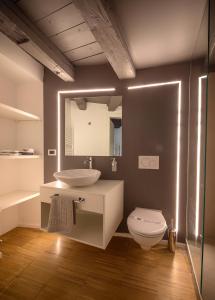 a bathroom with a sink and a toilet and a mirror at B&B Gli Scorci di Trento in Trento