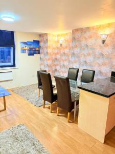 a dining room with a glass table and chairs at 2 Spacious Double Bedroom Apartment - Bradford in Bradford
