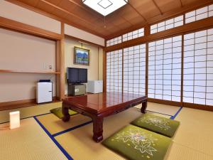 a room with a table and a board in it at KKR Kinosaki Genbu in Kinosaki
