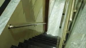 an escalator with a glass door and a staircase at FabHotel Star Hill in Mumbai +12 photos