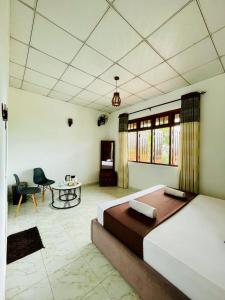 a bedroom with a bed and a table and a chair at Villa Avora Ridge in Kandy