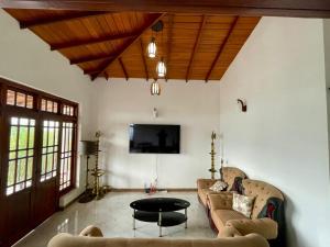 a living room with two couches and a table at Villa Avora Ridge in Kandy