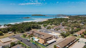 an aerial view of a resort with the beach at Priority Beach Stay in Coffs Harbour