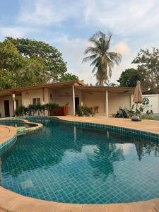 a swimming pool in front of a house at Tree Space Lanta Pool Stay Quiet & Near Beach in Ko Lanta