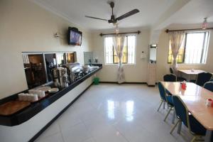 a large room with a kitchen with tables and chairs at Coastgate Hotel in Mombasa