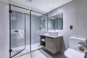 a bathroom with a sink and a shower and a toilet at 墨鐵會館 in Taichung