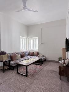 a living room with a couch and a coffee table at Ardor Homestay in Jabalpur