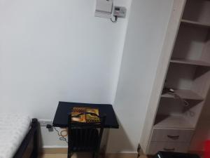 a small black table in a room with a closet at Annie's studio near Westside mall in Nakuru
