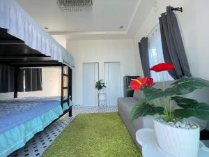 a bedroom with a bed and a potted plant at Earnhomestay sichon in Ban Plai Thon