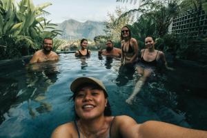 a group of people in a swimming pool at Sokkool Coliving and Coworking - Near Berawa Beach in Canggu