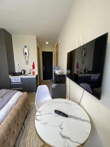 a room with a table with a remote control on it at Staunch Homes Luxury Studio Apartment in Nairobi