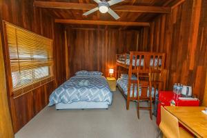 a bedroom with a bed and a ladder and a bunk bed at Kin Kin Retreat in Quinninup