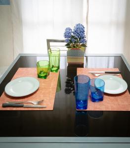 a table with plates and glasses on top of it at Dimora del Mare in Isola Bacucco +16 photos