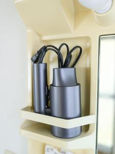 a couple of black utensils sitting on a shelf at ROOMzero 5号室 in Hanazonomachi +15 photos