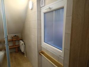 a small bathroom with a window and a shower at Apartments and rooms Cerkovnik in Bohinj +94 photos