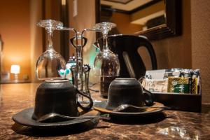two black tea cups on a table with wine glasses at Hotel Pharaoh-Adult Only in Sapporo +33 photos