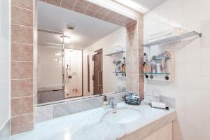 a bathroom with a sink and a mirror at Hotel Pharaoh-Adult Only in Sapporo