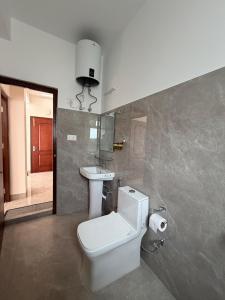 a bathroom with a toilet and a sink at Aga Stay Apartment in Gangtok +34 photos
