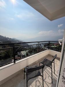 a balcony with two chairs and a table at Aga Stay Apartment in Gangtok
