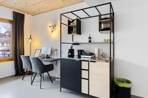 an office with a desk and a computer in a room at RS Boardinghouse Aparthotel mit Charme und Hotelservice in St. Gallen