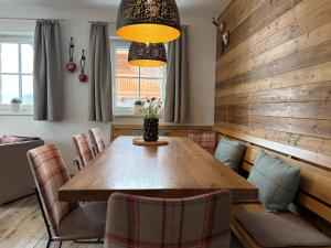 a dining room with a wooden table and chairs at Chalet in Niedernsill near Ski Slopes in Niedernsill