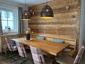 a dining room with a wooden table and chairs at Chalet in Niedernsill near Ski Slopes in Niedernsill