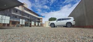 a white suv parked next to a building at Cesare in Uyuni