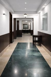 a hallway with a green floor in a building at Hotel Diplomat Residency in Bareilly