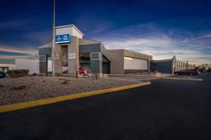 a gas station with a car parked in front of it at Suburban Studios, Kearney in Kearney