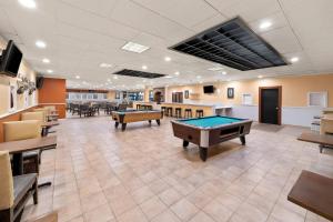 a billiard room with tables and ping pong balls at Suburban Studios, Kearney in Kearney