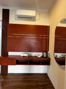 a kitchen with a wooden counter and a mirror at Stone Valley Resort & Beach in Tepus