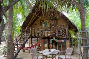 a tree house with a table and chairs in front of it at Lakdina Lodge in Panama