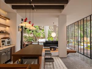 a kitchen and living room with a table and chairs at Hidden Valley Hotel-- New Hotel,A Hidden Gem,Serene Sanctuary,Exclusive Location,Swimming Pool & Cycling Route,Attraction Tickets Serivce in advance,Affordable Luxury,Best Karst Mount View in Yangshuo in Yangshuo