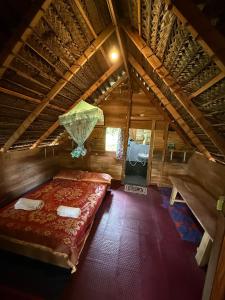 a bedroom with a bed in a wooden attic at Lakdina Lodge in Panama