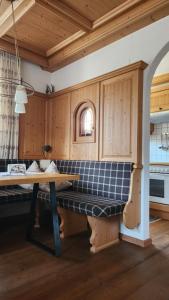 a kitchen with a bench in the middle of it at Appartements Familie Eberharter in Finkenberg