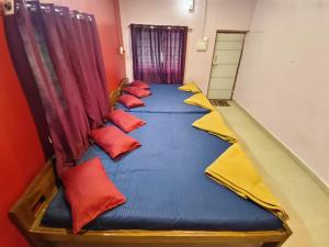 a group of pillows on a bed in a room at Greenwoods Resort Dandeli in Kervād