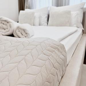 two white beds with towels on top of them at Local-Lux Premium Apartment- 2 Bedrooms Balcony -2 Private Parking in Kecskemét