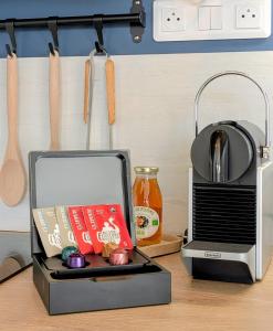 a kitchen counter with a toaster and a box of food at Le Solent in Courseulles-sur-Mer