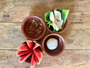 three bowls of food on a wooden table at Lakdina Lodge in Panama