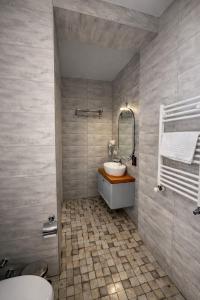 a bathroom with a sink and a mirror at Hotel Green Town in Kutaisi
