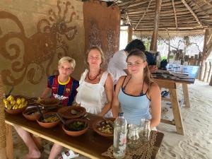 a woman and two girls sitting at a table with food at Lakdina Lodge in Panama +12 photos