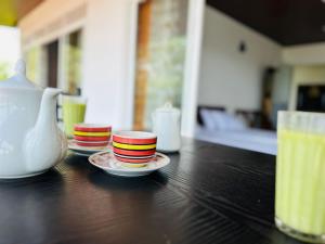 three stacks of plates on a table with a vase at Mount Vista Homestay Kandy in Kandy