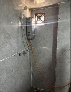 a room with a heater and an orange cord hooked up to a wall at Highcamp B&B in Namche +3 photos