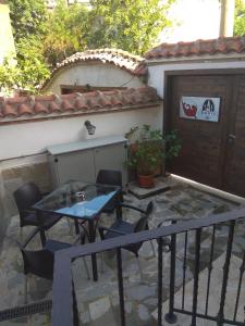a patio with a table and chairs next to a building at Roots Hotel Old Town in Plovdiv